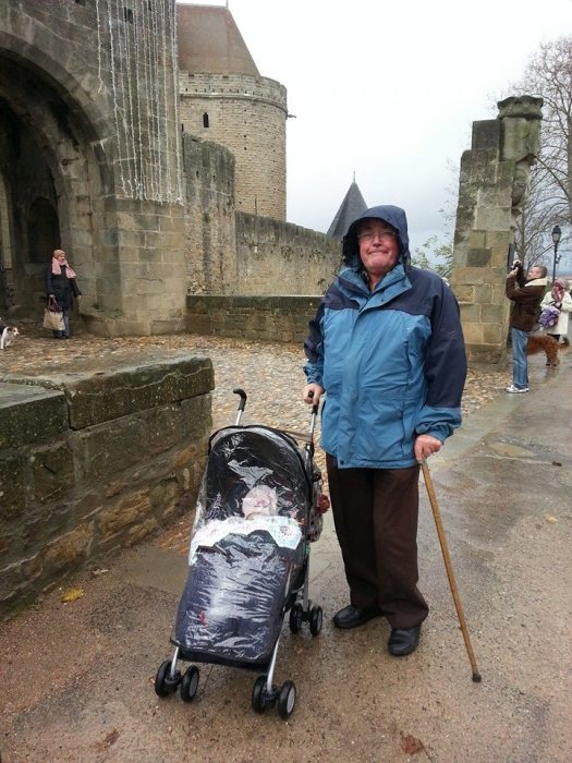 Baby and grandad in drizzly Carcassonne
